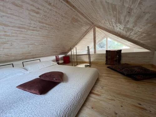 a bedroom with a bed with a hat on it at Eco-Chic Retreat: Countryside Oasis Near Florence in Pozzolatico
