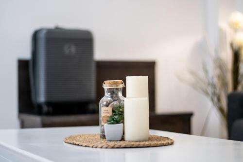 a candle and a glass jar on a table at Boutique Hotel Kredo in Herceg-Novi