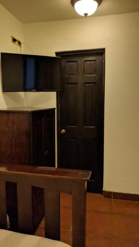 a room with a wooden table and a door at Hotel Posada de la Luna in Antigua Guatemala