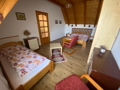 a room with two beds and a living room at Berek Ház in Balatonberény