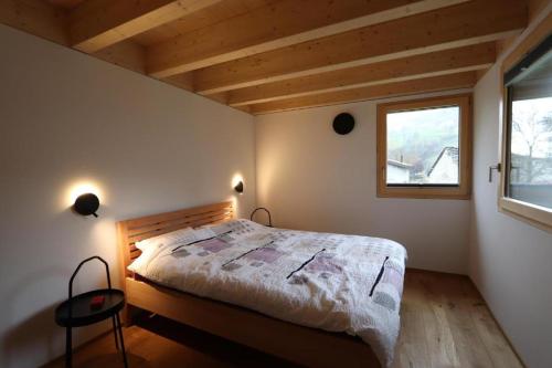 a bedroom with a bed and a window at Ca' dal Nos in Olivone