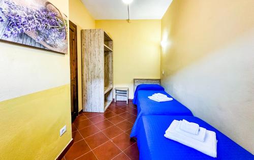 Кровать или кровати в номере Residence Hotel La Pelosetta