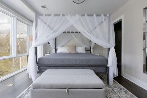 a bedroom with a bed with a canopy at Modern Townhome, Large Game Room with Ping Pong, 10min to Downtown! Sleeps 10! in Nashville