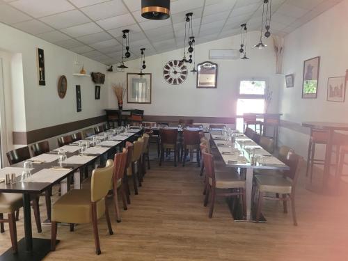 a row of tables and chairs in a dining room at Village 17 gites, Piscine, Restaurant , 2 gites avec SPA, 3km de Conques in Conques