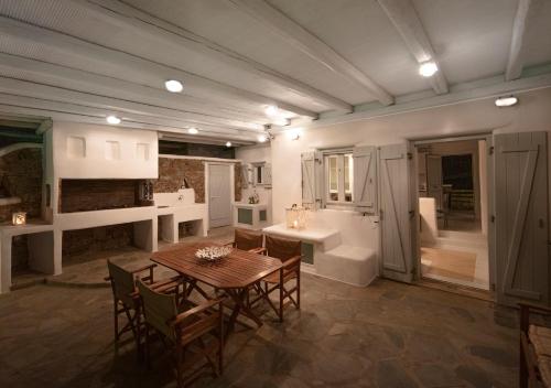 a kitchen with a table and chairs and a bathroom at Villa Lucia kalafati area in Kalafatis