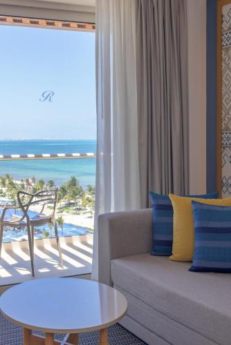 a living room with a couch and a view of the beach at Royalton Splash Riviera Cancun, An Autograph Collection All-Inclusive Resort in Cancún