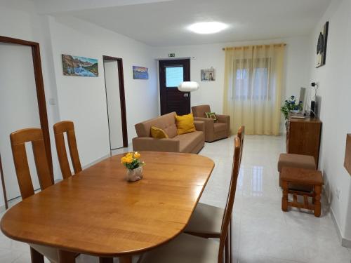 a dining room with a table and a living room at Casa d'Avó in Araújo