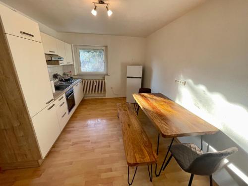 a kitchen with a wooden table and chairs in it at Appartement Luna in Schweinfurt