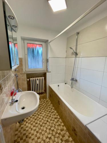 a bathroom with a tub and a sink and a bath tub at Appartement Luna in Schweinfurt