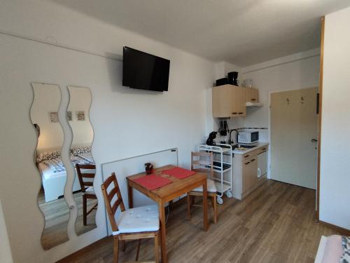 a small kitchen and dining room with a table and chairs at Landhaus Danita in Bodensdorf