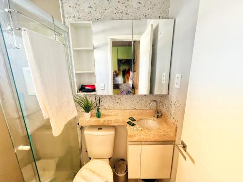 a bathroom with a toilet and a sink and a mirror at O Berço do Samba Carioca in Rio de Janeiro