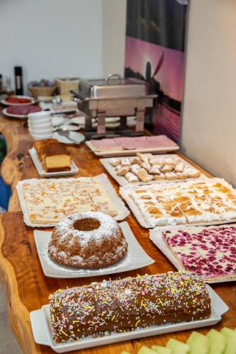 a table topped with lots of different types of pastries at Hotel Cumbres del Sur in Pucón