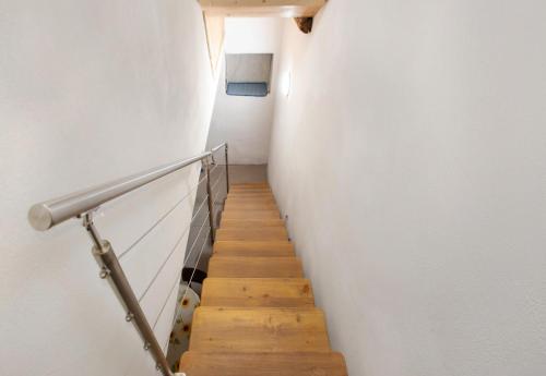 a hallway with a staircase with a white wall at Premesan 4 in Bormio
