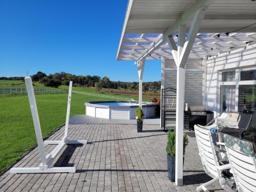 a patio with a pergola and a swimming pool at Domek na Pagórku in Lwówek Śląski
