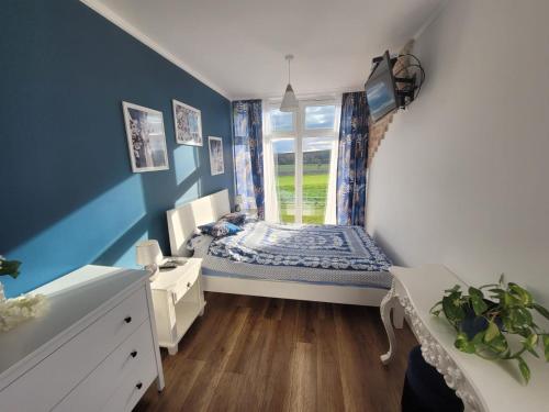 a small bedroom with a bed and a window at Domek na Pagórku in Lwówek Śląski