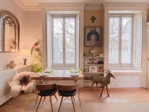 a dining room with a table and chairs in a room at Urban Oasis Hideaway in London