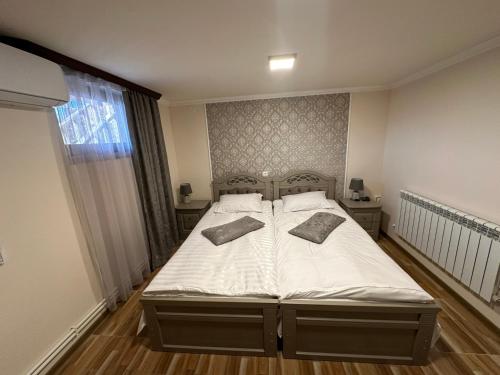 a bedroom with a bed with two pillows on it at Colibri Hotel in Haghpat