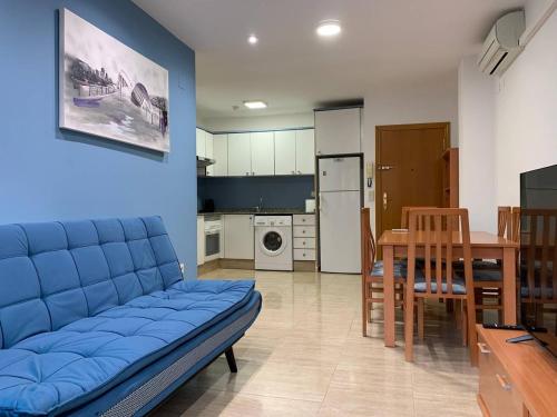 a living room with a blue couch and a table at Experience Valencia Bnb - Rincon del Mar - Apartamento Maravilloso a Canet Playa 100 mt in Canet de Berenguer