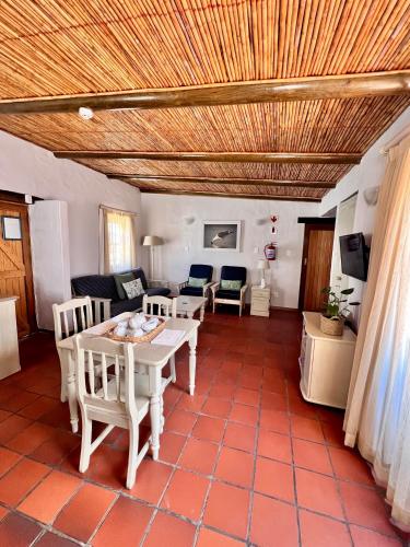 a living room with a table and chairs at Baywatch Paternoster - The Cottage in Paternoster