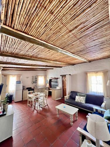 a living room with a couch and a table at Baywatch Paternoster - The Cottage in Paternoster