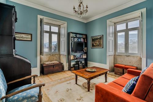 a living room with a couch and a table at Casa da Avó in Caminha