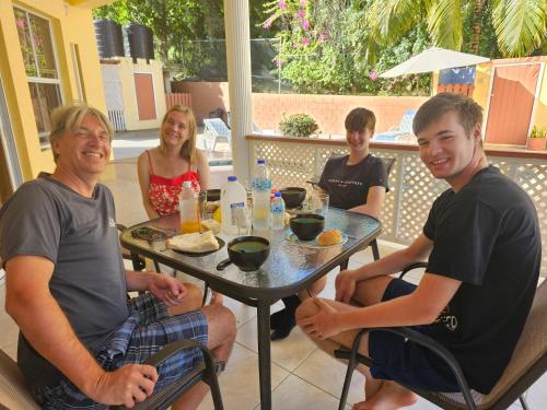 a group of people sitting around a table at Royal Escape - 2 in Anse La Raye