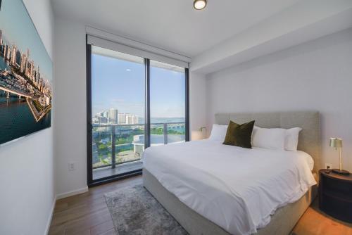 a bedroom with a large bed and a large window at Luxury Apt with Amazing City Views All of Miami in Miami