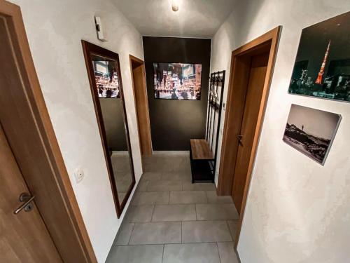 a hallway with a stairway with a view of a room at Stilvolles Apartment - mit E-Auto Lademöglichkeit in Attendorn