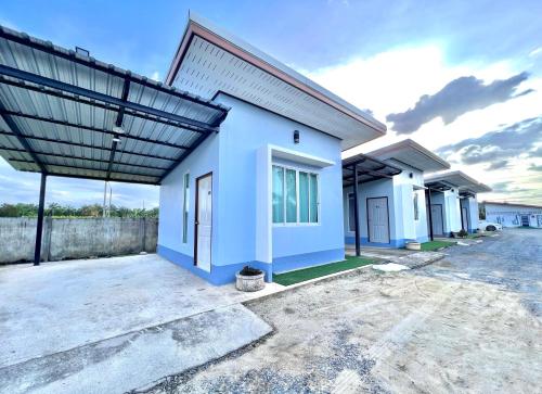 a blue house with a roof at Rim Suan Resort in Satun