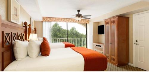 a bedroom with two beds and a large window at Westgate Towers Resort in Orlando
