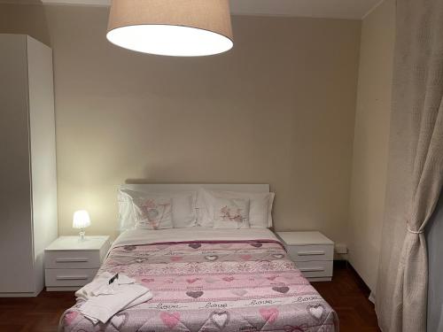 a bedroom with a large bed with a pink blanket at Villa Mase in Ravenna