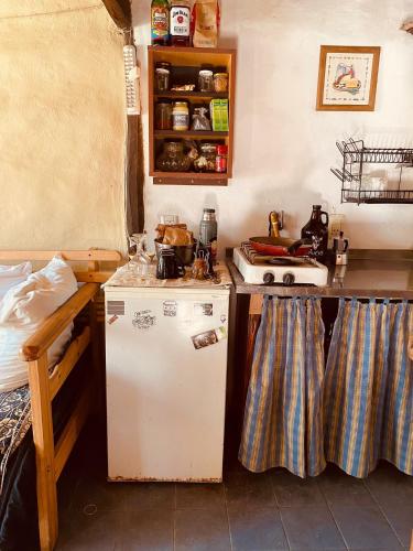 a kitchen with a stove and a refrigerator in it at El Hobbit in Villa General Belgrano