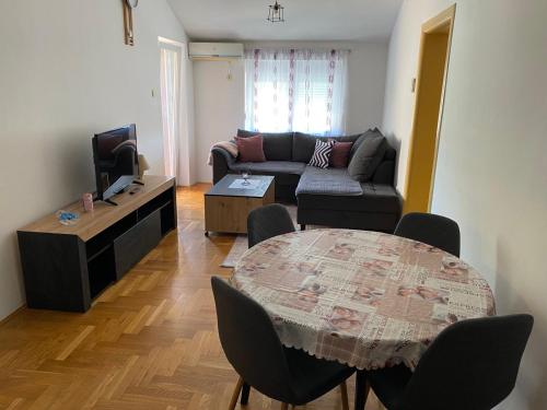 una sala de estar con un sofá y una mesa en Apartman DIS, en Trebinje