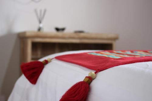 a bed with a red and white blanket on it at Private Villa Kayu Padangbai in Padangbai