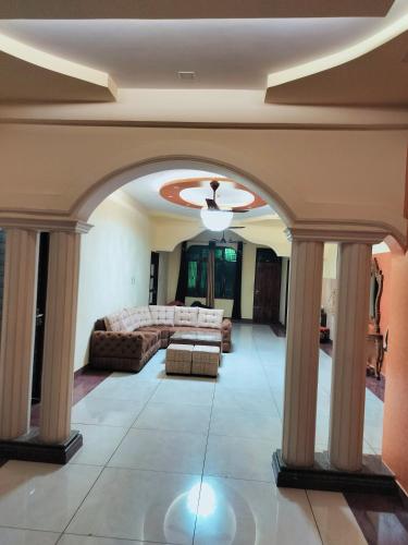 a living room with a couch and a ceiling at Shree Nanda Guest House in Varanasi