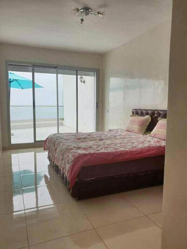 a bedroom with a bed with a view of the ocean at Holikeys - Agadir - 2 Ch - Aourir 005 in Agadir