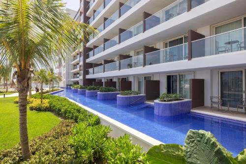 an image of an apartment building with a swimming pool at Royalton Splash Riviera Cancun, An Autograph Collection All-Inclusive Resort in Cancún