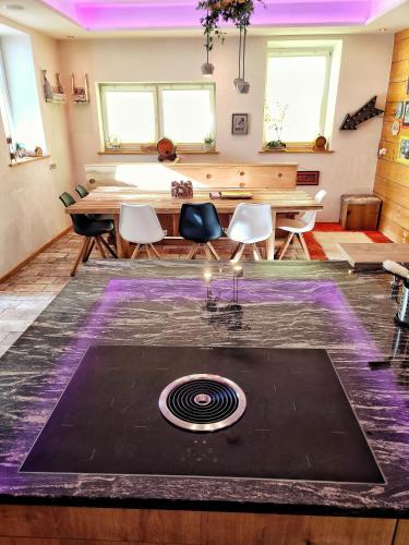 a dining room with a table and a purple rug at Das Mountain Getaway - Exclusive Mega Chalet Stubai Super Card in Fulpmes