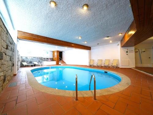 a large swimming pool in a large room with a ceiling at Hotel Arlecchino - Dada Hotels in Madesimo