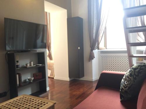 a living room with a television and a couch at ITD unione in Milan