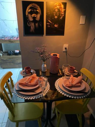 a table with plates of food on top of it at SUA CASA EM GARANHUNS Aptº INTEIRO COM 04 QUARTOS in Garanhuns