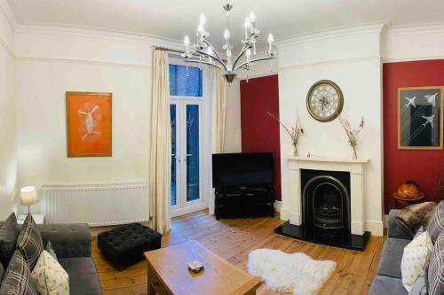 a living room with a couch and a fireplace at Close to castle + Parking for 4 Cars in Lincolnshire