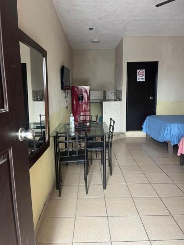 a room with a table and chairs and a bed at LOSSANTOS in Matamoros