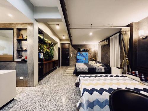 a bedroom with two beds and a plant at Old Town- mimi cozy studio *70 SQM good for family in Bangkok
