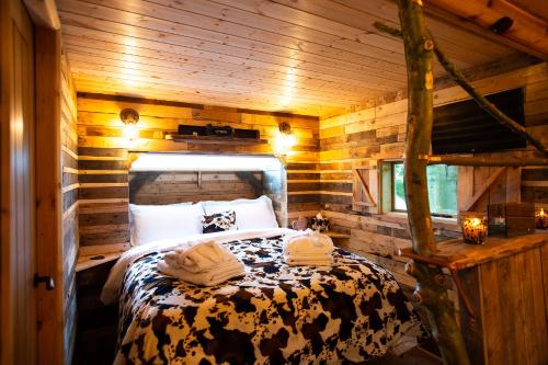 a bedroom with a bed in a wooden cabin at Tree House in Thirsk