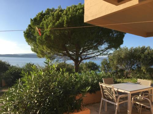 a table and chairs with a view of the water at Galini Studios and Apartments in Lassi