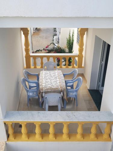 a table and chairs sitting around a table on a balcony at MAISON SIDI BOU SAID in Hammamet