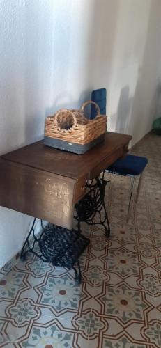 a wooden table with a basket on top of it at Bonita Casa Señorial en pleno casco antiguo de Nijar in Níjar