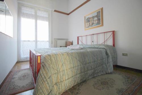 a bedroom with a bed with a blanket on it at Nina House in Desenzano del Garda