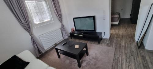 a living room with a television and a coffee table at Ferienwohnung Sigmarino in Sigmaringen